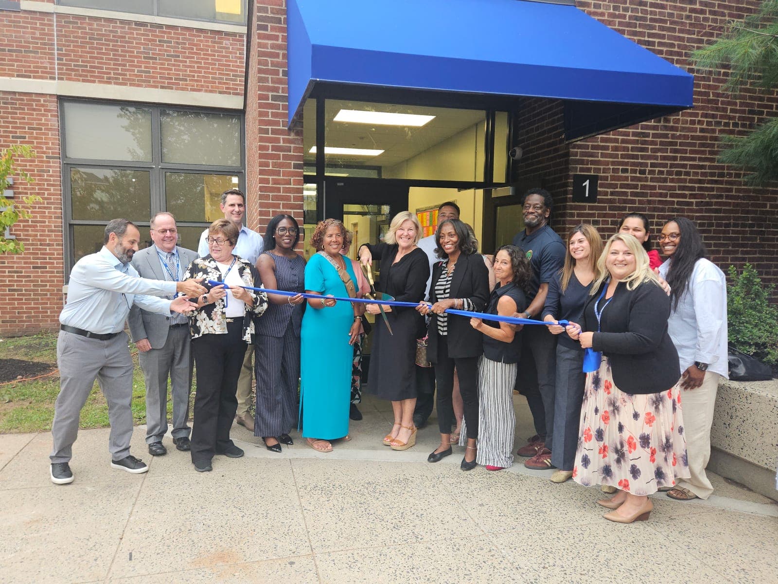 District and municipal representatives join La Grande Elementary School staff for a ribbon-cutting ceremony.