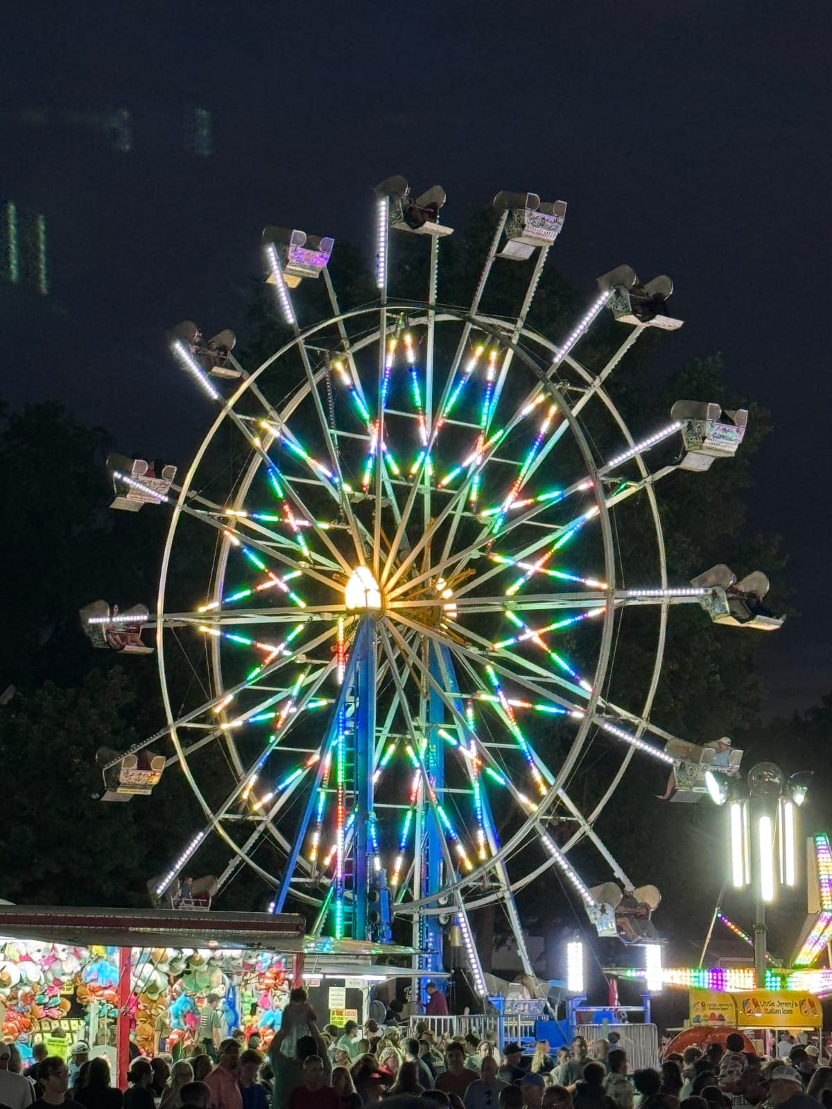 Festival rides illuminated the St. Bart’s grounds during an evening of the Labor Day Italian Festival.